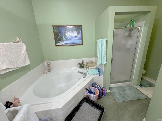 bathroom with a stall shower and a bath