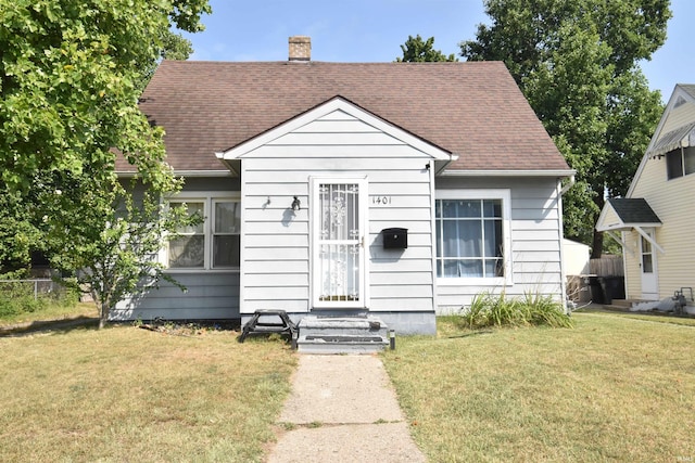 bungalow-style house with a front lawn