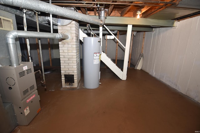 basement featuring electric water heater and brick wall