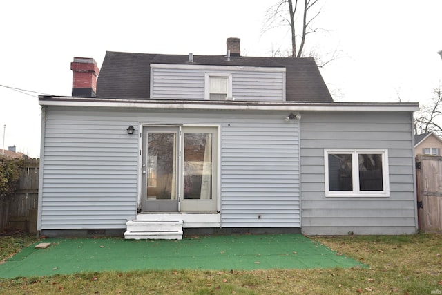 rear view of house with a lawn