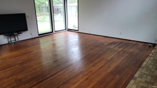 unfurnished living room with dark hardwood / wood-style flooring