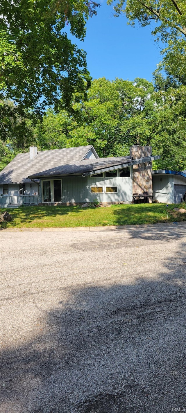 view of front of house featuring a front yard and a chimney