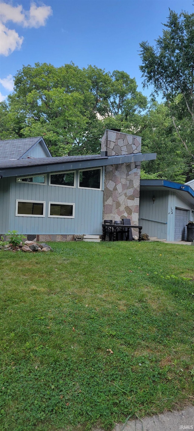 exterior space featuring a lawn and a garage