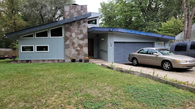 view of front of house with a garage and a front lawn