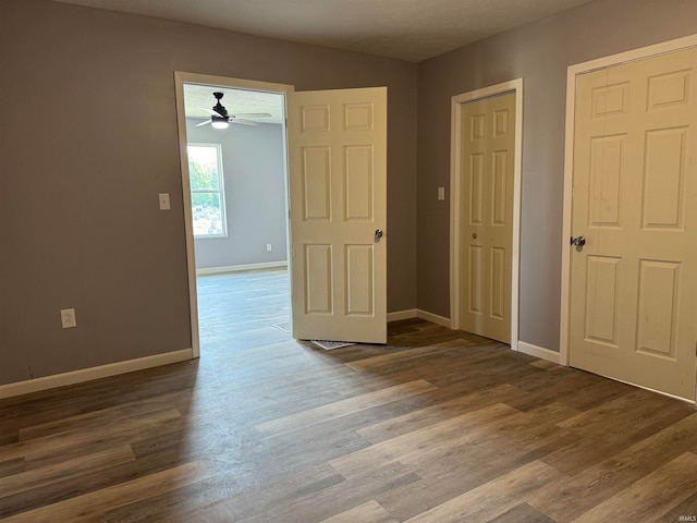 unfurnished room with ceiling fan and hardwood / wood-style floors