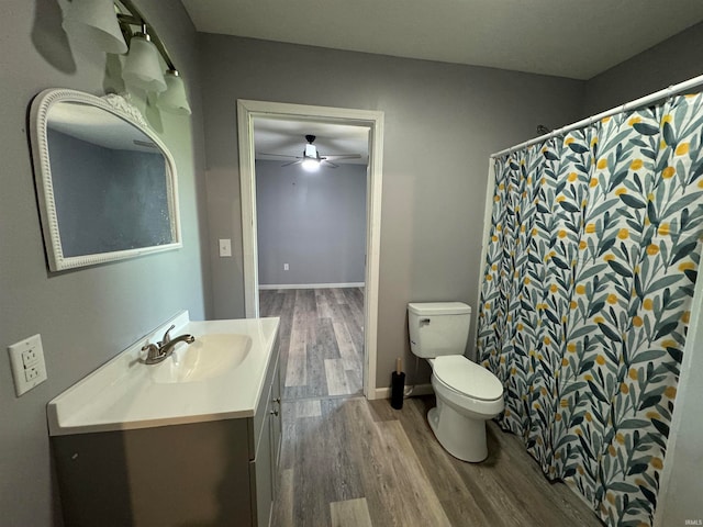 bathroom with ceiling fan, wood-type flooring, toilet, and vanity