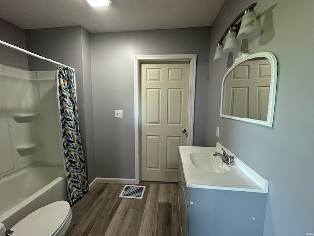 full bathroom with toilet, hardwood / wood-style floors, vanity, and shower / bath combo with shower curtain