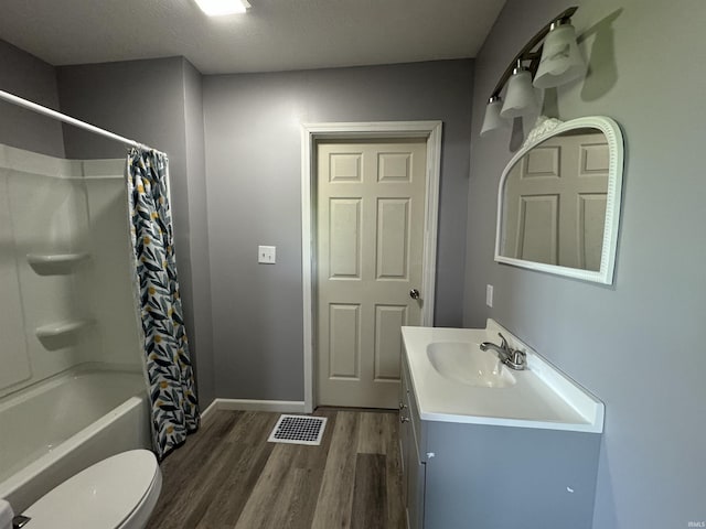 1302 21st St, Bedford, IN 47421 - full bathroom featuring toilet, wood finished floors, vanity, shower / bath combination with curtain, and baseboards