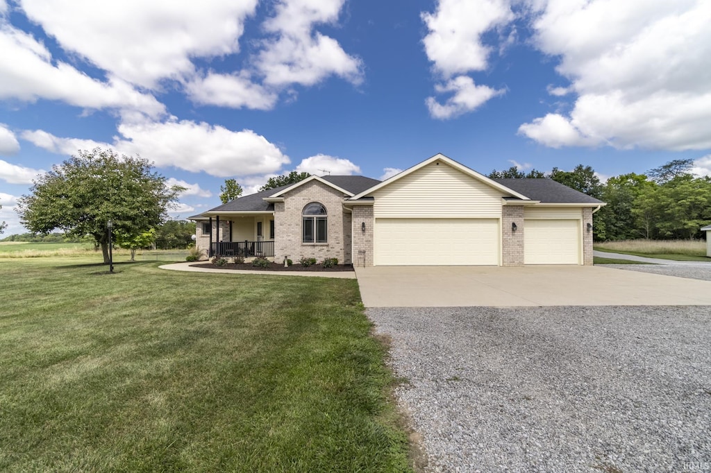 ranch-style home with an attached garage, covered porch, brick siding, driveway, and a front yard