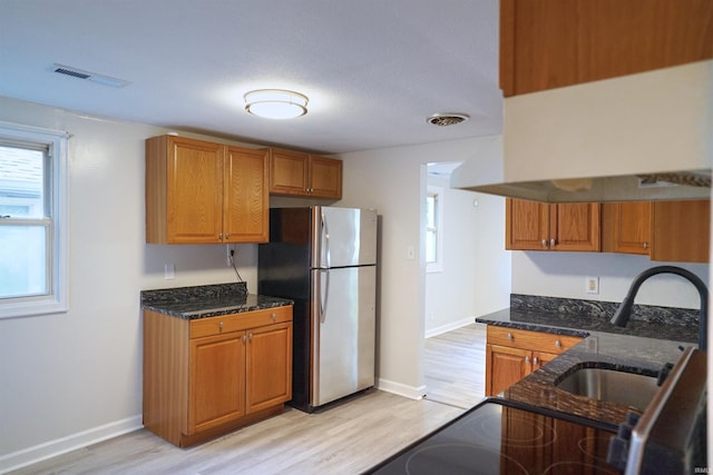 kitchen with plenty of natural light and light hardwood / wood-style floors