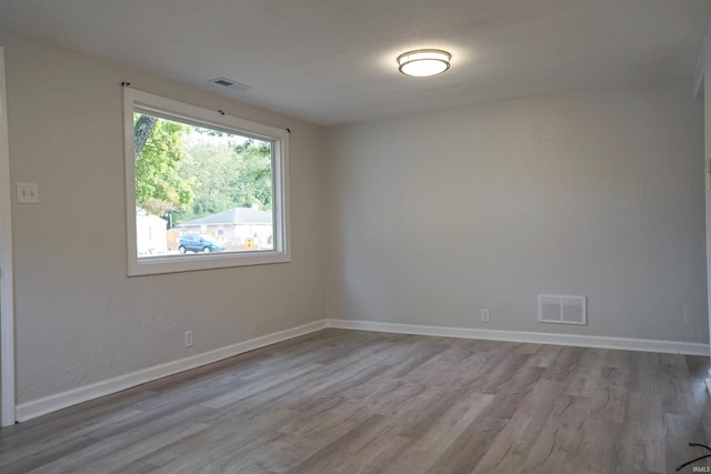 unfurnished room with wood-type flooring