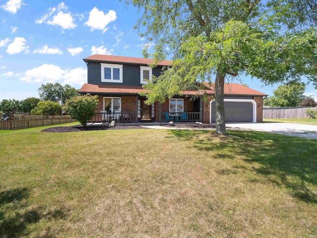 view of front facade featuring a front lawn, a garage, and covered porch