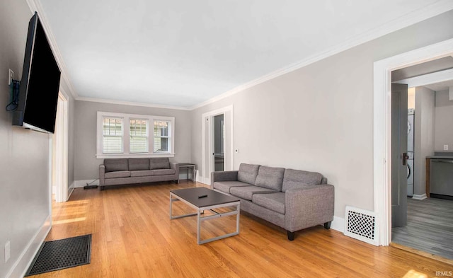 living room with light hardwood / wood-style flooring and ornamental molding