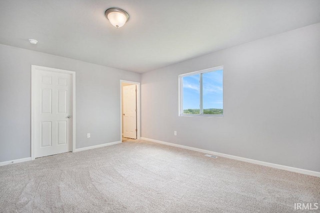 unfurnished room with light colored carpet