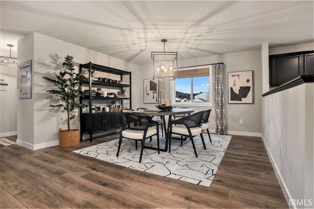 dining space with an inviting chandelier and wood-type flooring