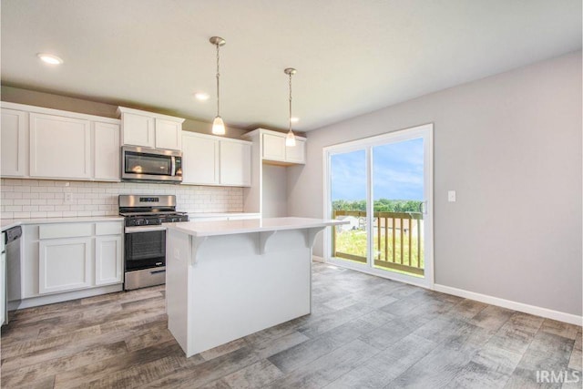 kitchen with a center island, light hardwood / wood-style floors, tasteful backsplash, white cabinetry, and stainless steel appliances