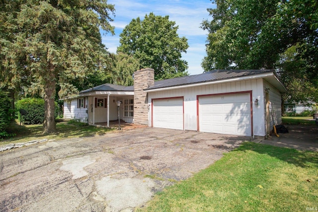 single story home with a front lawn and a garage