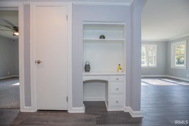 unfurnished office featuring ceiling fan, dark hardwood / wood-style flooring, and ornamental molding