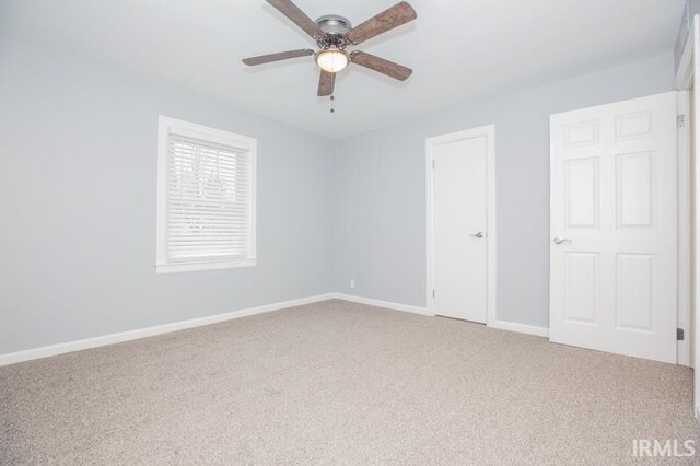 carpeted empty room featuring ceiling fan and a healthy amount of sunlight