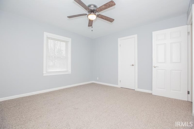 unfurnished bedroom with ceiling fan, carpet floors, and baseboards