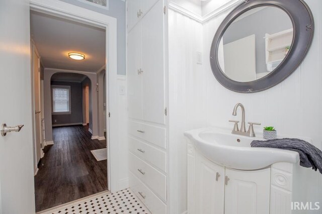 bathroom with tile patterned flooring, a shower with door, vanity, and toilet