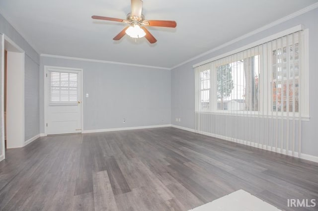 empty room with dark wood-type flooring, crown molding, baseboards, and ceiling fan