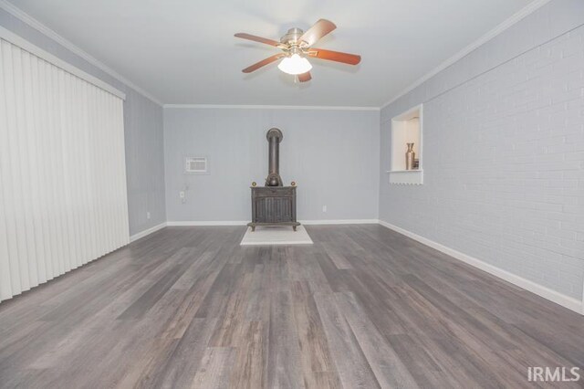 unfurnished living room with a healthy amount of sunlight, dark hardwood / wood-style flooring, and a wood stove