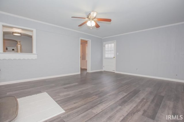 unfurnished room featuring ornamental molding, a ceiling fan, baseboards, and wood finished floors