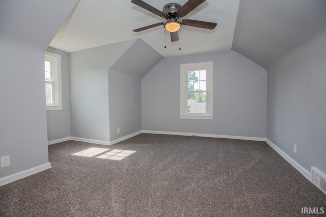 additional living space featuring lofted ceiling, plenty of natural light, and baseboards