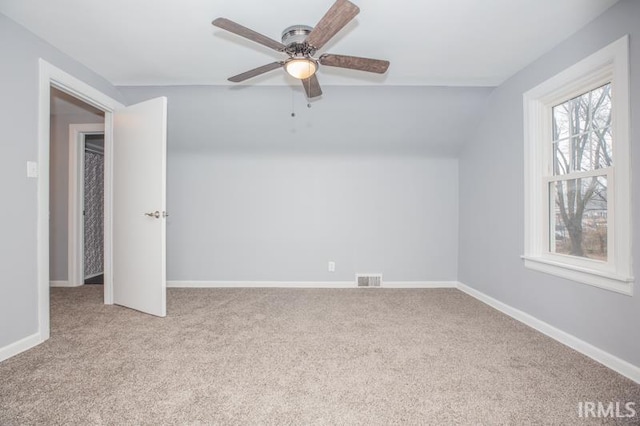 unfurnished bedroom featuring ceiling fan, visible vents, baseboards, and light colored carpet