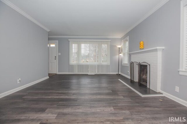 unfurnished living room featuring a fireplace, ornamental molding, and hardwood / wood-style flooring