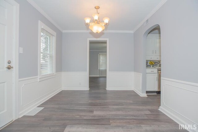 unfurnished room featuring ornamental molding and dark hardwood / wood-style flooring