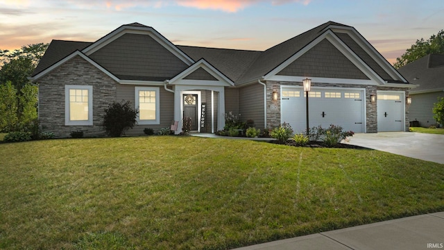 craftsman-style house featuring stone siding, an attached garage, concrete driveway, and a lawn