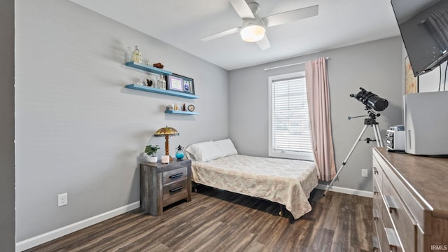 bedroom with dark wood-style floors, ceiling fan, and baseboards