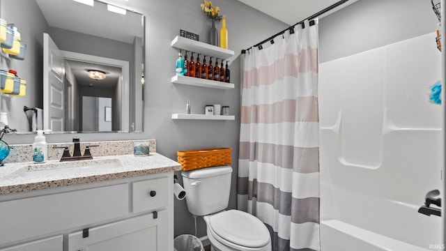 full bathroom featuring toilet, shower / bath combo with shower curtain, and vanity