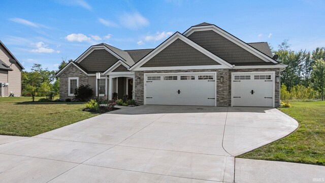 craftsman-style home with a front lawn and a garage