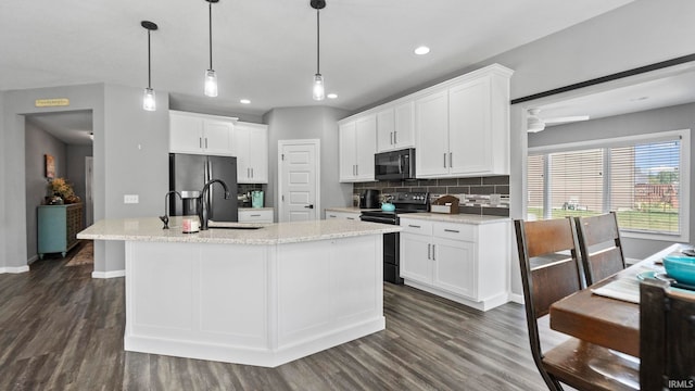 kitchen featuring dark wood-style floors, white cabinets, black appliances, and tasteful backsplash