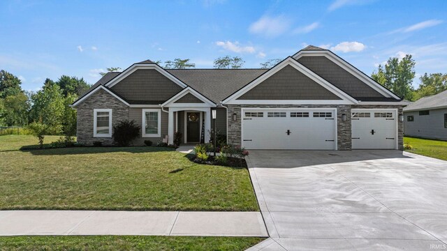 craftsman-style house featuring a garage and a front lawn