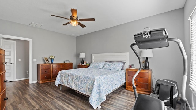 bedroom with dark wood-style floors, baseboards, visible vents, and a ceiling fan