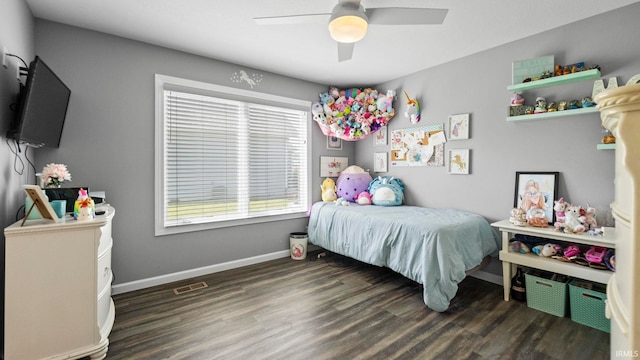 bedroom with ceiling fan, wood finished floors, visible vents, and baseboards