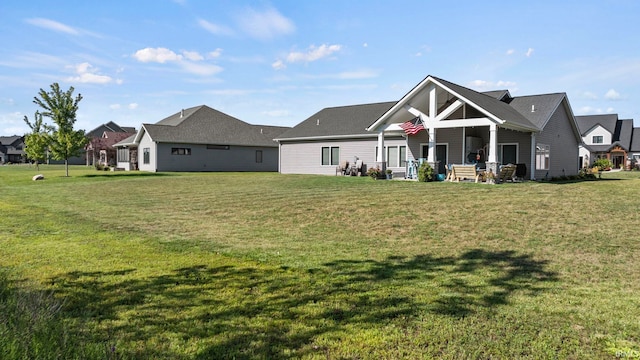 back of house featuring a yard and a porch