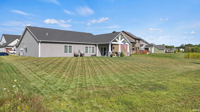 back of house with a lawn