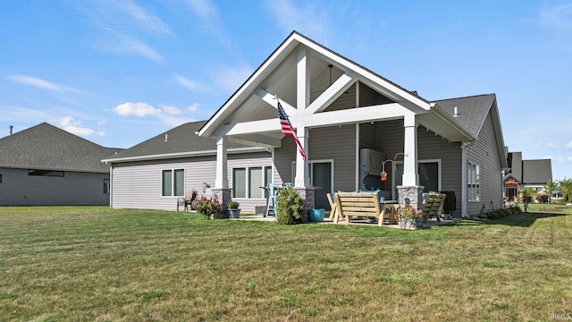 rear view of property featuring a lawn