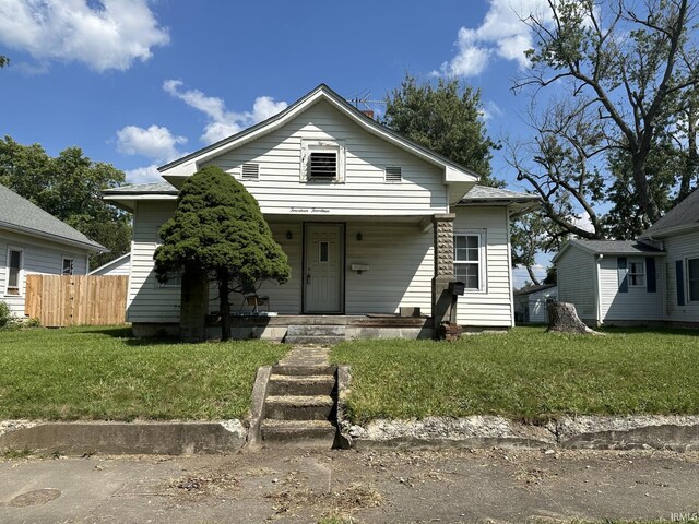 bungalow-style house with a front lawn