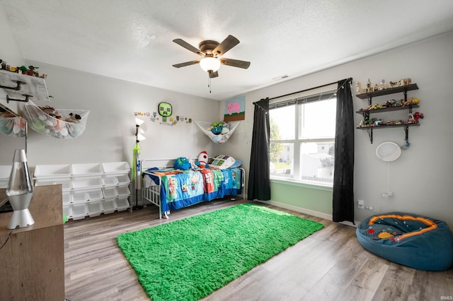 3128 Springwater Ct, Kokomo, IN 46902 - bedroom with wood finished floors, a textured ceiling, baseboards, and ceiling fan