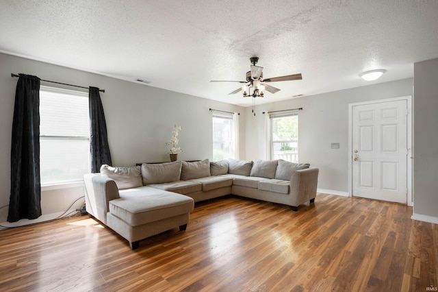 3128 Springwater Ct, Kokomo, IN 46902 - living area featuring a textured ceiling, wood finished floors, ceiling fan, and baseboards
