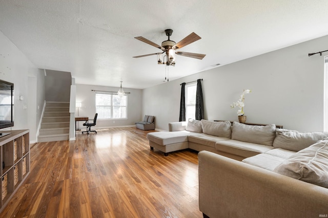 3128 Springwater Ct, Kokomo, IN 46902 - living area with wood finished floors, stairway, ceiling fan, and baseboards