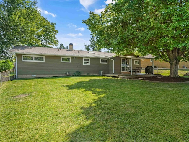 back of house featuring fence, central AC, a chimney, a yard, and crawl space