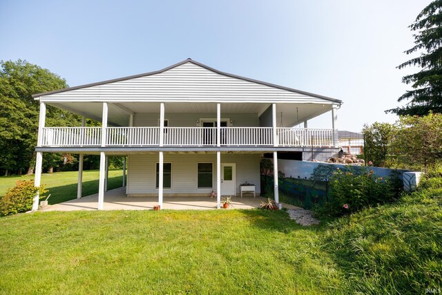 rear view of property with a yard and a patio