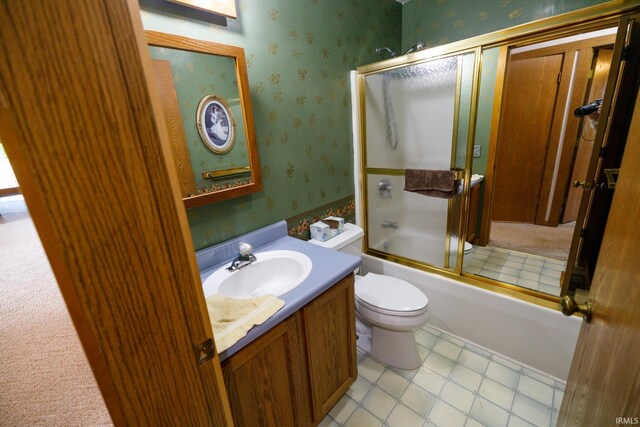 full bathroom featuring tile patterned flooring, combined bath / shower with glass door, toilet, and vanity